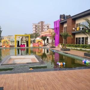 a pool of water in the middle of a city at Riyank Farms in Patna