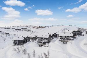 a ski lodge in the snow on a mountain at Kikut Alpin Lodge 2102 in Hol