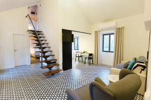 a living room with a spiral staircase and a table at Sintra Bliss A Part in Sintra