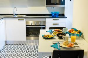 a kitchen with two plates of food on a table at Sintra Bliss A Part in Sintra
