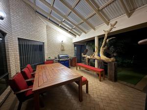 a living room with a wooden table and chairs at Marina Park View in Port Lincoln