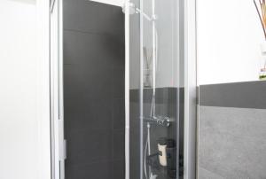 a shower with a glass door in a bathroom at Terrazza in centro Valsassina in Introbio +38 photos