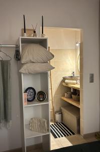a white book shelf with pillows on top of it at Un Chalet au Verger-Dog friendly-Jacuzzi & Massages in Conteville