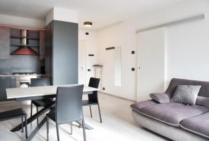 a living room with a table and a couch at Terrazza in centro Valsassina in Introbio