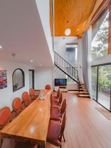 a large dining room with a large wooden table and chairs at Thung May Resort - Venuestay in Ba Vì