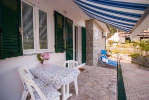 a table and chairs on the porch of a house at Cala Azzurra in Marciana