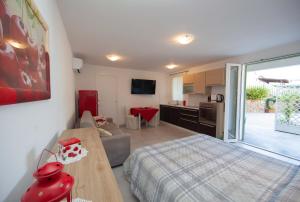 a bedroom with a bed and a kitchen and a living room at Cala Azzurra in Marciana