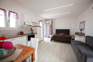 a living room and kitchen with a couch and a table at Cala Azzurra in Marciana