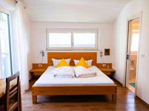 a bedroom with a large bed with yellow pillows at B&B Chalet Andy in Schenna