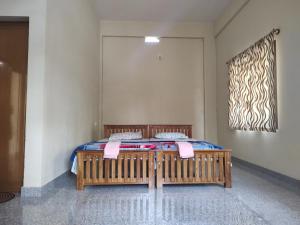 a bed in a room with pink towels on it at Bridgettine Paradise in Sultan Bathery