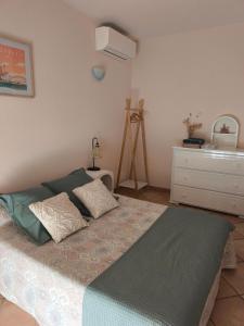 a bed with two pillows on it in a room at Chambre double lumineuse in Millas