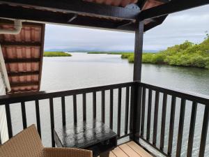 a balcony with a view of a river at Six Pillars Resort in Bastimentos