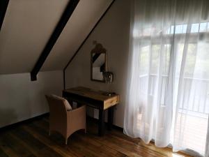 a desk and a chair in a room with a window at Six Pillars Resort in Bastimentos