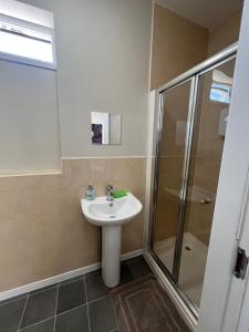 a bathroom with a sink and a shower at Comfy private studio Moseley in Birmingham