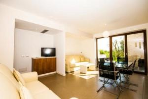a living room with a couch and a table and a television at Eurocongressi Hotel in Cavaion Veronese