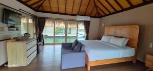 a bedroom with a bed and a couch and a television at Ruknam Resort in Ban Hin Hak +125 photos