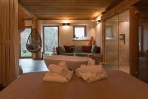 a bathroom with a tub and towels on a counter at Chalet Noèr in Ledro +56 photos