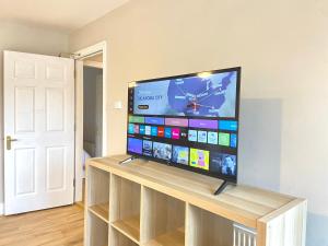 a flat screen tv sitting on top of a wooden stand at Anchors Rest, Cobh in Cobh +5 photos