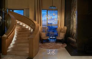 a staircase with two chairs and a table and a window at Hyatt Regency Tashkent in Tashkent