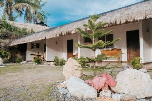 a house with rocks in front of it at Meg's Resort in Andoon