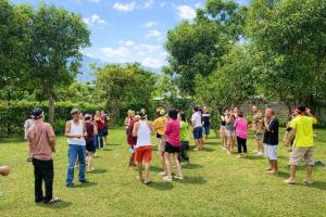 a large group of people standing in a field at Orchid Villa & Homestay Farm Lăng Cô in Thôn An Cư Ðông