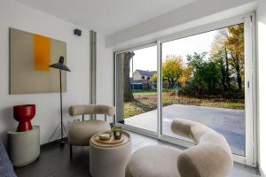 a living room with a large sliding glass door at Villa de rêve - Climatisation - Sauna - Spa - babyfoot - Arcade in Quatzenheim