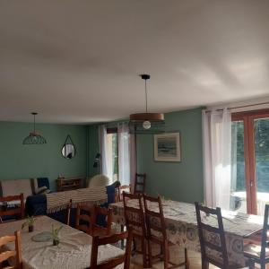 a dining room with a table and chairs and a room with a table at Les balcons du Haut-Forez in Chalmazel Jeansagniere