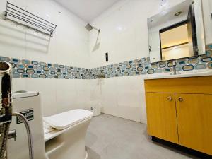 a bathroom with a toilet and a sink and a mirror at Hotel Prime Stay in Noida