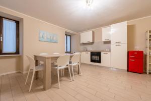 a kitchen with a table and chairs and a red refrigerator at Al Lago da Lilly in Gargnano