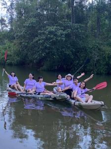 a group of people sitting on a raft in the water at Orchid Villa & Homestay Farm Lăng Cô in Thôn An Cư Ðông +53 photos