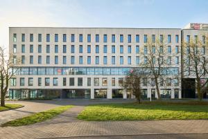an office building with a lot of windows at Aparthotel Symphony Krakowska 35 by INA in Wrocław