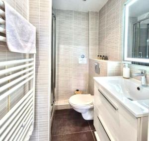 a white bathroom with a toilet and a sink at Cozy Bosio - Studio de charme Cours Saleya in Nice