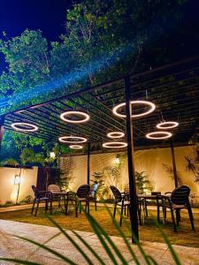 a group of tables and chairs under a roof at Holiday One Hotel & Suites - DHA-8 in Karachi