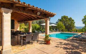 a patio with a table and chairs next to a pool at Moscari in Moscari