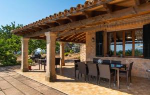 a patio with tables and chairs under a wooden pergola at Moscari in Moscari