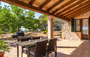 a patio with a table and chairs and a grill at Moscari in Moscari