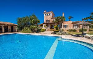 a large swimming pool in front of a house at Can Palleta Nou in S'Horta