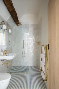 a bathroom with a shower and a sink and a toilet at Number One Bruton in Bruton