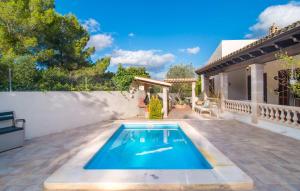 a swimming pool in the backyard of a house at Pomeres Nou in Sa Coma