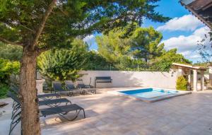 a patio with a tree and a swimming pool at Pomeres Nou in Sa Coma