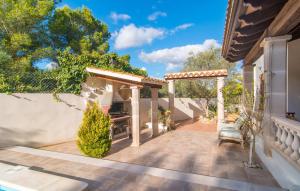 a patio with a pergola and a table and bench at Pomeres Nou in Sa Coma +39 photos