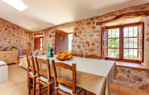 a kitchen and dining room with a table and chairs at Rustica Es Seguers in Fornalutx