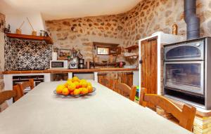 a kitchen with a table with a bowl of fruit on it at Rustica Es Seguers in Fornalutx