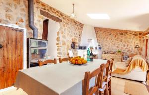 a kitchen and dining room with a table and chairs at Rustica Es Seguers in Fornalutx