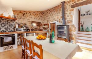 a kitchen with a table with a bowl of fruit on it at Rustica Es Seguers in Fornalutx