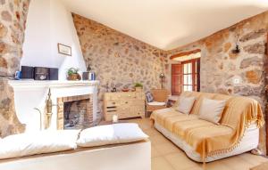 a living room with a couch and a fireplace at Rustica Es Seguers in Fornalutx +23 photos