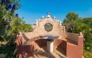 a small fountain in front of a building at Silencio in Cala Ratjada