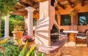 a patio with a stone fireplace in a yard at Silencio in Cala Ratjada