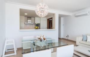 a living room with a glass table and white chairs at Minimal in Can Picafort +19 photos