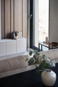 a living room with a vase sitting on a couch at Aparthotel Symphony Krakowska 35 by INA in Wrocław +80 photos